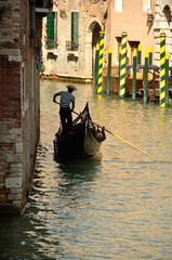 Fototapeta na wymiar typical venetian gondola with gondoliere, Venice, Italy