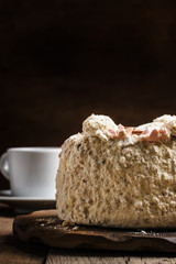 Meringue cake and a cup of coffee, vintage wooden background, se