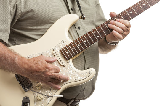 Closeup Of Senior Man Playing Electric Guitar Over White Background. Selective Focus On Hands On Fret Board Neck.