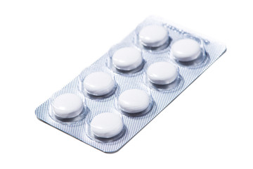 Packings of pills and capsules of medicines on white background