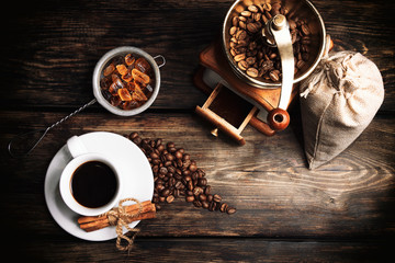 Taste cup of coffee with roasted grains (Cup of black coffee, fried coffee grains, coffee grinder and caramelized sugar)