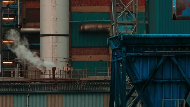 An ultra close-up shot of a plume of smoke coming out of a sugar factory chimney
