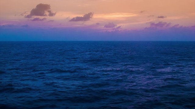 Vibrant Colored Sunset or Sunrise from a Moving Ocean Going Ship at Sea with Lower Composition