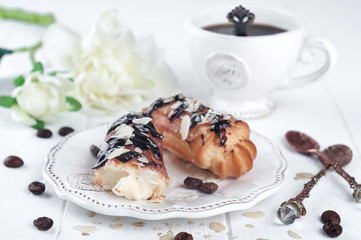 Tasty eclairs on table
