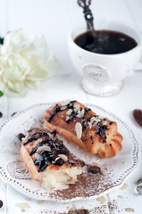 Tasty eclairs on table