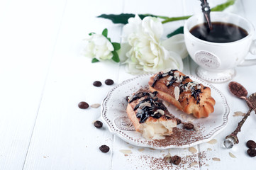 Tasty eclairs on table