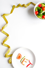 concept slimming diet fresh vegetables on white background top view