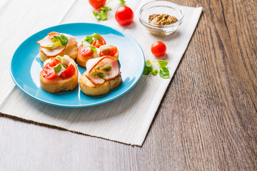 Bruschetta with tomato, cheese and bacon