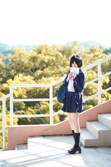Obraz premium Asian girl in uniform with love letter