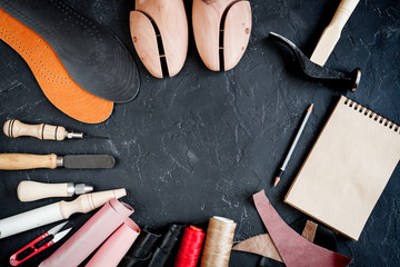cobbler tools in workshop dark background top view mock up