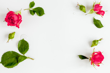 berry color decorative cosmetics with roses white background top view