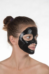 Happy beautiful girl with acne on a white background in a cosmet