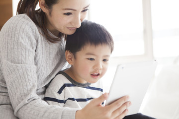 Mother and son are watching animation on tablet
