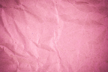 Pink crumpled recycle paper background.