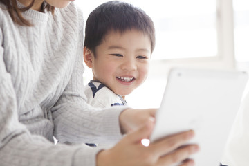 Mother and son are watching animation on tablet