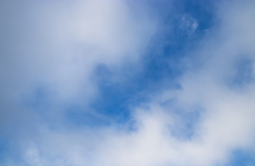blue sky with clouds and fog