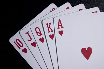 royal flush poker card on dark black background