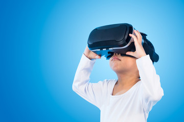 Asian Chinese little girl experiencing virtual reality eyeglasss