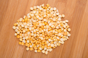 Yellow split peas isolated on a wood background
