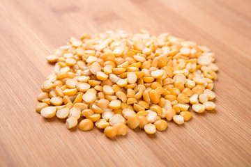Yellow split peas isolated on a wood background