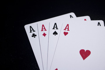 ace four of a kind poker card on dark black background