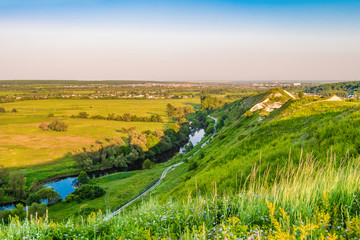 Obraz premium View of plain and river valley from a high hill. Town Shebekino