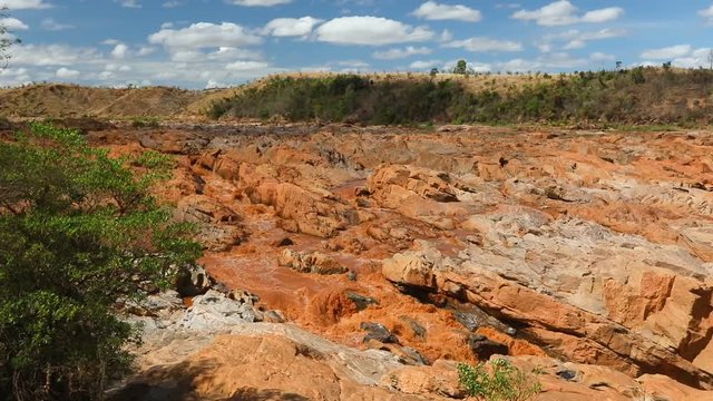 Beautiful view of Betsiboka River stream with red sediments. In rainy season flooding its banks and flooding nearby. Maevatanana, Mahajanga province. Madagascar landscape.
