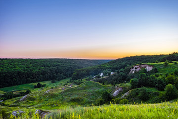 Evening forest on chalk mountains. Camping tourists. Summer land