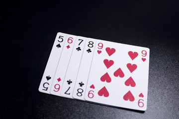 straight poker card on dark black background