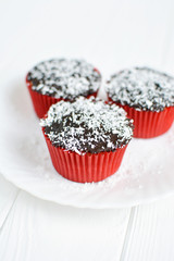 Homemade cupcakes with chocolate glaze and coconut