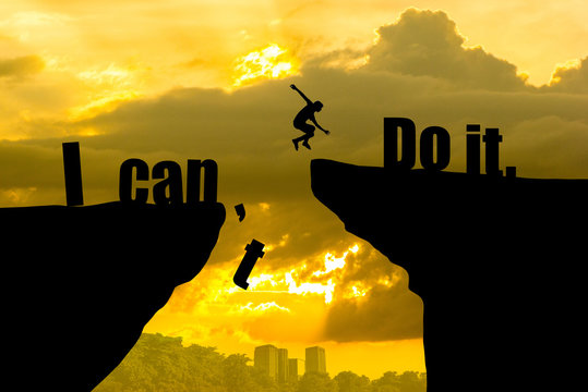 Man jumping on I can do it or I can't do it text over cliff on sunset background,Business concept idea