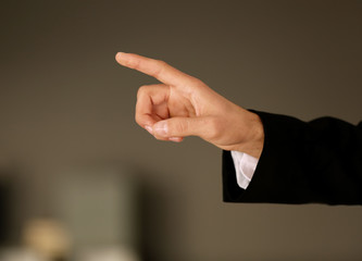 Male hand with finger pointing on blurred background