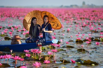 Fotobehang Laos woman in flower lotus lake, Woman wearing traditional Thai people , Red Lotus Sea UdonThani Thailand © saravut