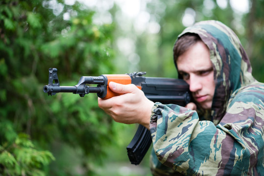 Armed soldier in camouflage with a Kalashnikov assault rifle, so