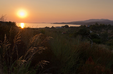Sunset at Toroni bay with Aegean sea and mount Olimp in background, Stihonia, Greece - obrazy, fototapety, plakaty