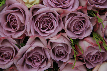 Purple roses in a wedding arrangement