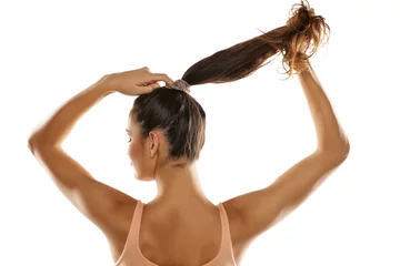 Plexiglas keuken achterwand Kapsalon young woman tied her hair in a ponytail