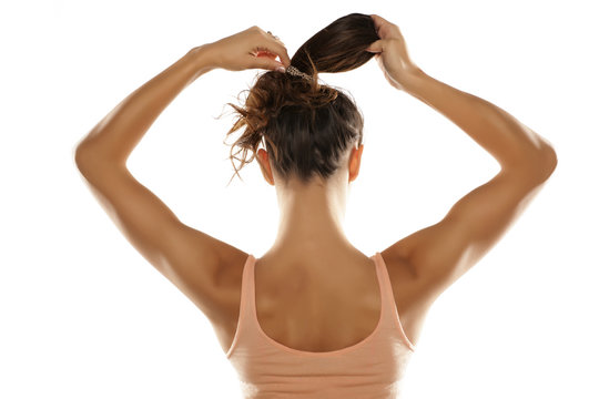 young woman tied her hair in a ponytail