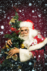 Santa claus hugs xmas tree