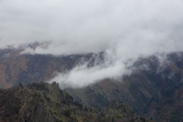 Fototapeta na wymiar The formation and movement of spring clouds over the high Caucasus mountains