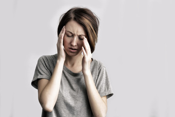 Naklejka premium girl suffers from terrible headaches and compresses the head with hands