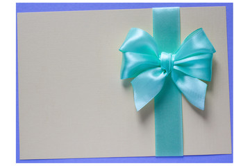 Turquoise bow and ribbon on card