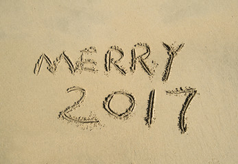 merry 2017 written in sand write on tropical beach
