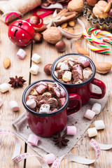 Hot chocolate with marshmallows and spices on christmas table
