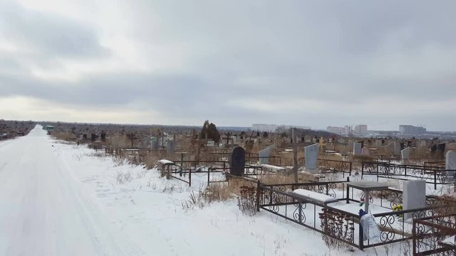 Old cemetery in winter time. Steadicam shot.