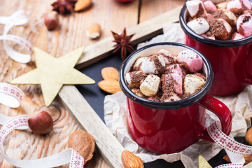Hot chocolate with marshmallows and spices on christmas table