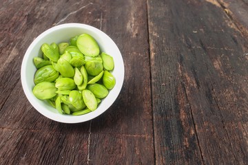 Parkia speciosa  in white cup on the wooden floor background 