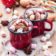 Hot chocolate with marshmallows and spices on christmas table