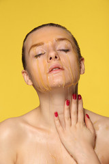 Beautiful woman with honey on her face