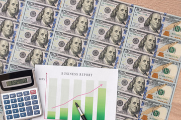 financial chart, dollar, calculator and pen on desk.